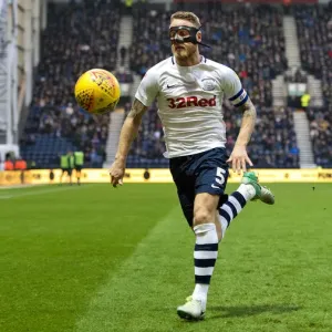 A Masked Tom Clarke Chases The Ball At Deepdale A Masked Tom Clarke Chases The Ball At Deepdale