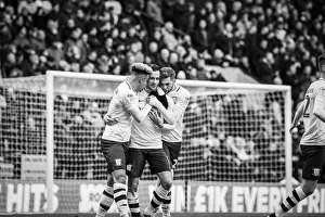 Championship Prints: Three of the four goalscorers celebrate together with an embrace as PNE beat